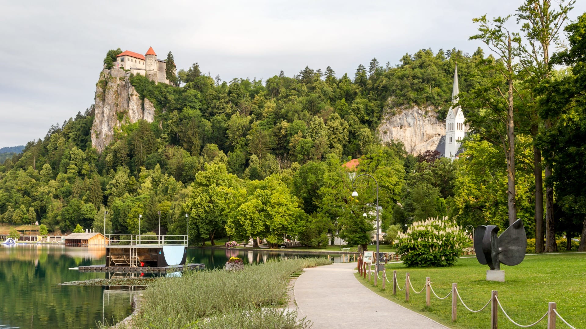 Lakeside promenade at Lake Bled with Bled Castle on the cliff above