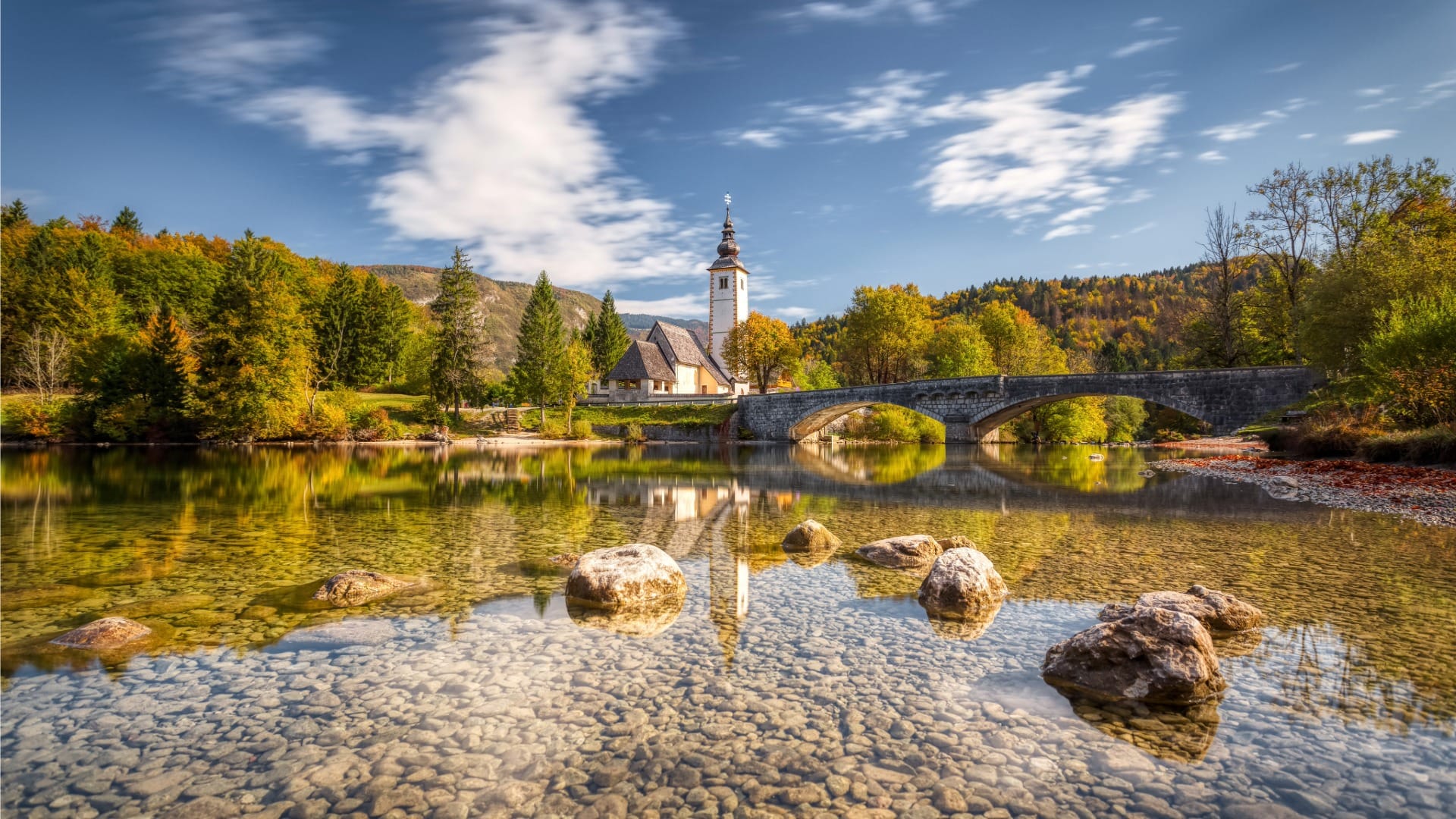 Stone bridge and the church of St John the Baptist at Ribcev Laz on Lake Bohinj