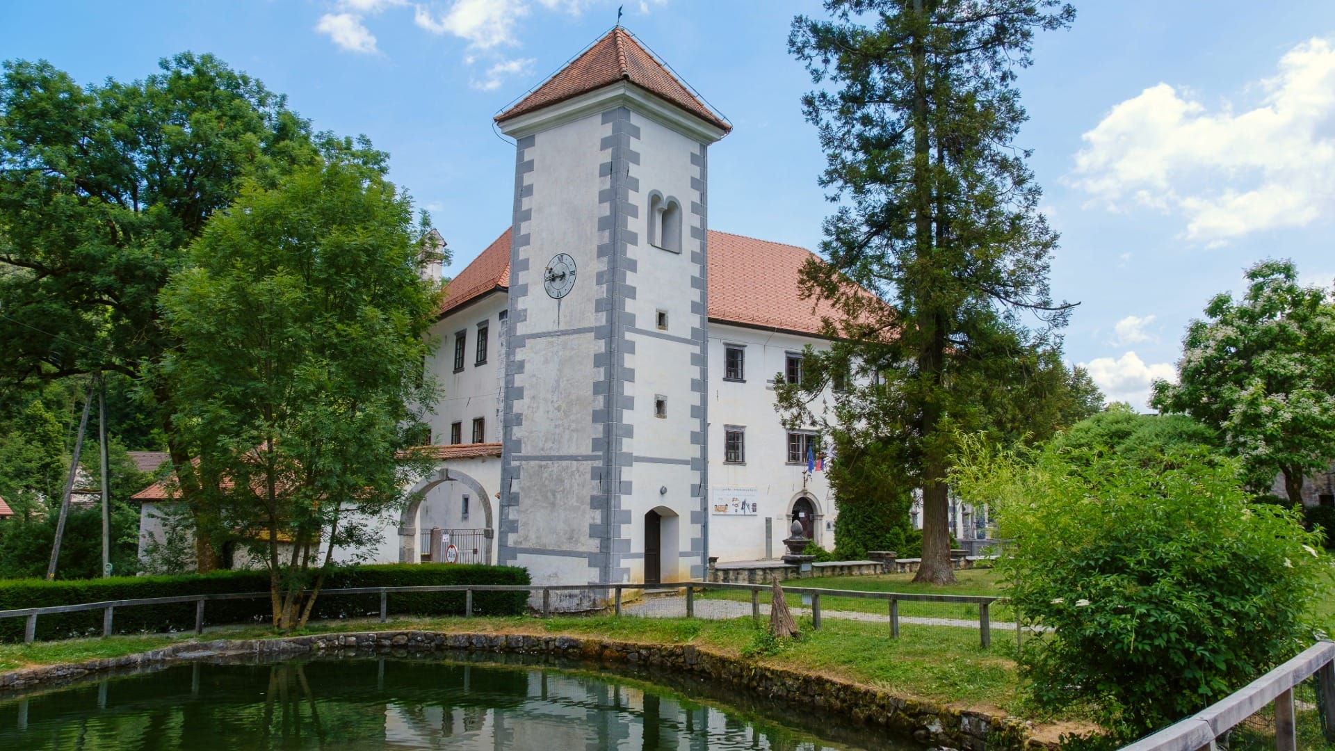 The clock tower and moat of Polhov Gradec castle near the start of the loop