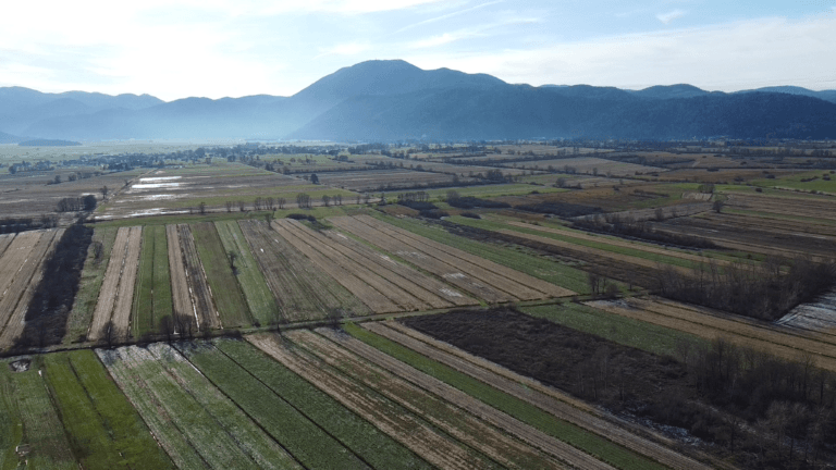 Aerial view of Mount Krim rising above the farmland of the Ljubljana Marshes