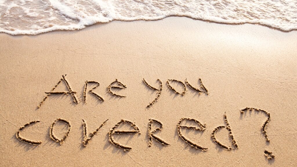 Are you covered written in the sand on a beach