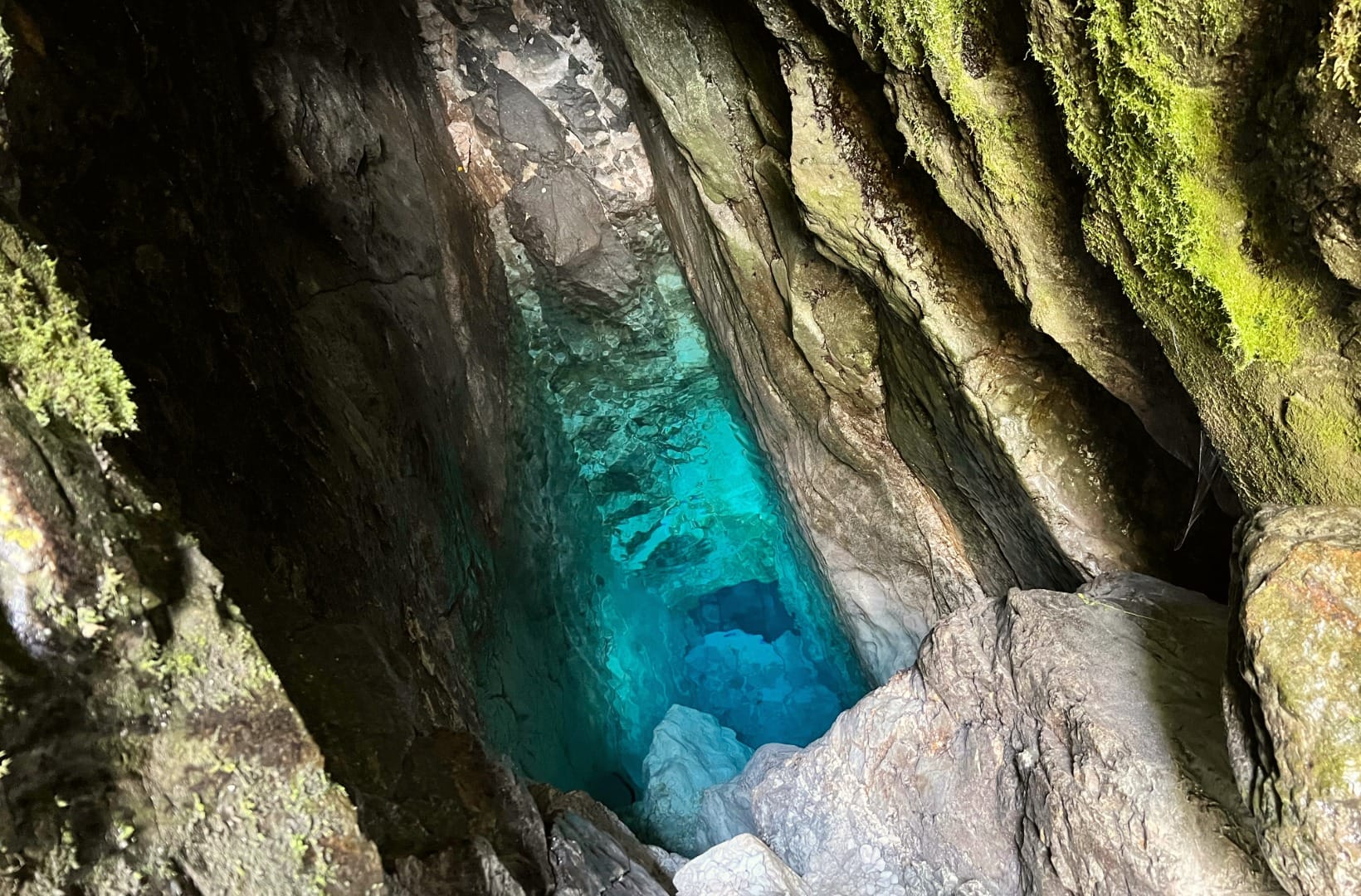 Turquoise water in a deep, narrow cleft in the rock at the source of the Soča near Trenta
